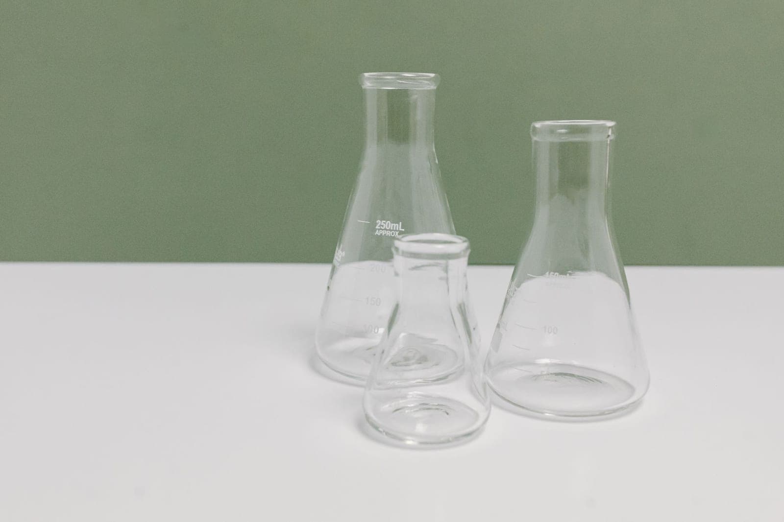 Empty glass laboratory flasks on a clean bench — generic lab equipment, no product packaging.